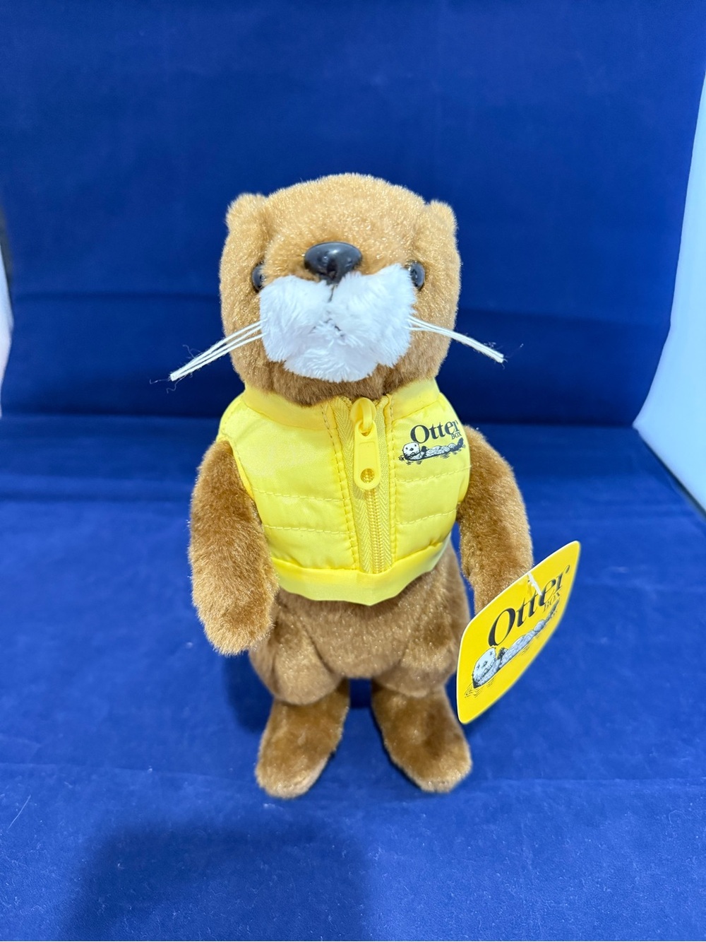 OtterBox Ollie Plush with Bright Yellow Puffer Vest